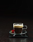 Espresso with chilli in glass cup and saucer