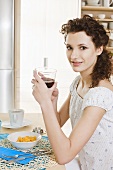 Young woman eating red fruit juice for breakfast