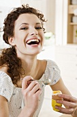 Young woman eating boiled egg for breakfast