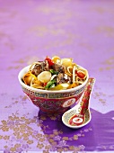 Asian noodles with crispy pork and water chestnuts