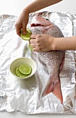 Stuffing a fish with lime slices