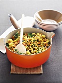Rice with spinach and sweet potatoes in pan