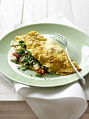 Omelette filled with tomato, feta and mushrooms