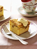 Piece of apple crumble cake with cream