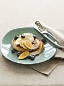 Pancakes with bananas, blueberries and cream