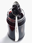 Blackberry and elderberry jelly in jar with spoon