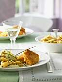 Potato and asparagus salad with breaded turkey escalopes