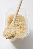Long-grain rice in a plastic container