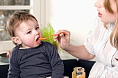 Toddler being fed baby food