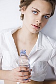 Young woman with a bottle of mineral water