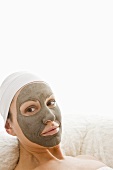 Woman with healing clay facial mask