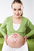 Pregnant woman with stick figure girl drawn on her bump