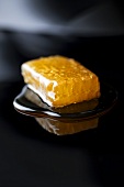 Honeycomb with honey on reflective surface