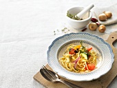 Spaghetti with fried vegetables and thyme