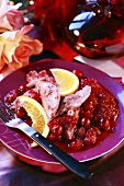Goose with cranberry sauce and orange wedges