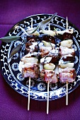 Duck, bacon and onion kebabs (overhead view)