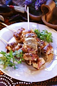Chicken and bacon kebabs in nut sauce