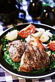 Grilled beef with spinach, tomatoes and onions