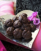 Chocolate biscuits on heart-shaped silver plate
