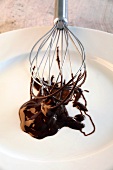 Melted chocolate on plate with whisk
