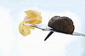 Black truffle (Périgord truffle) and ribbon pasta on slicer