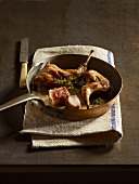 Braised duck pieces in a frying pan