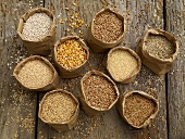 Various types of cereal grains in paper bags