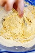 Making pasta dough: mixing eggs and flour