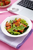 Spinach and strawberry salad with balsamic vinegar, notebook