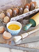 Baking ingredient: beaten eggs in a bowl, egg box