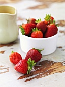 Strawberries in a bowl, cream jug