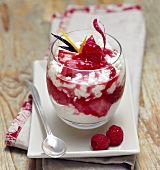 Rice pudding with raspberry and rhubarb compote in a glass