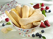 A bowl of sponge fingers and fresh berries