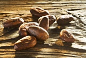 Roasted cocoa beans on wooden board