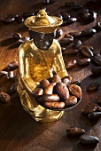 Gilded statuette holding and surrounded by cocoa beans