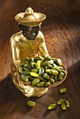 Gilded statuette with shelled pistachios