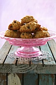 Almond macaroons with raisins on pink cake stand