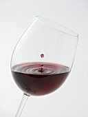 Glass of red wine with drop of wine