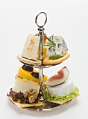 Assorted cheese appetisers on tiered stand