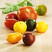 Various types of tomatoes with drops of water