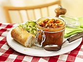 Goulash in jar with cucumber salad and baguette