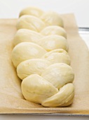 Bread plait (unbaked) on baking parchment