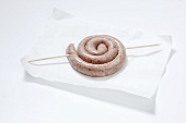 Coiled sausage on paper