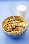 Muesli with dried fruit and nuts and a glass of milk