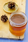 Pine honey in a jar with pine cones