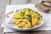 Scrambled egg with spring onions and bread