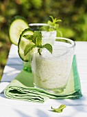 Yoghurt and cucumber drinks with mint on table out of doors