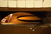 Farinata (chick-pea flatbread, Italy) in wood-fired oven