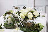 Arrangement of white roses and myrtle in resin pot