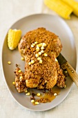 Chicken with spicy crust and corn on the cob